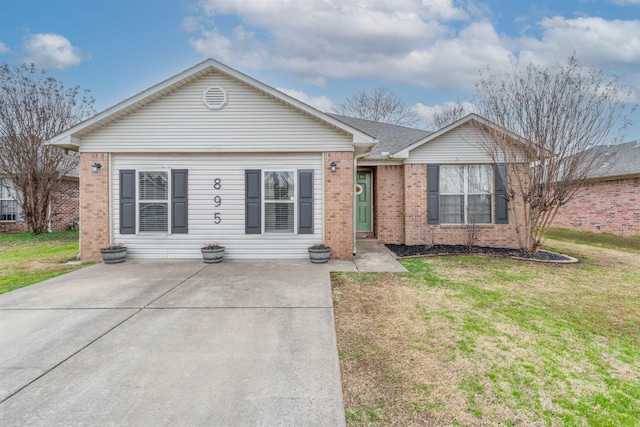 ranch-style house with brick siding and a front yard