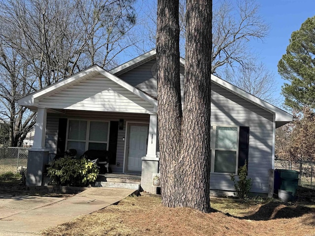 view of front of home with a porch and fence