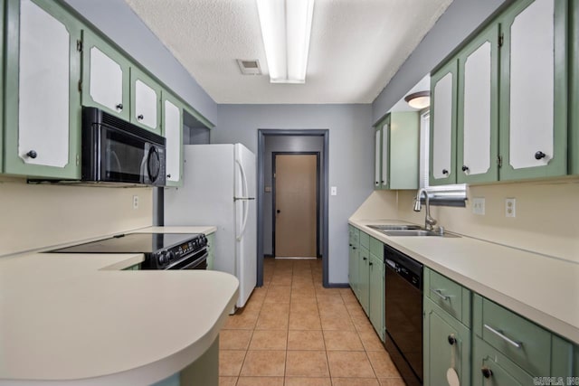 kitchen featuring a sink, visible vents, black appliances, and green cabinets