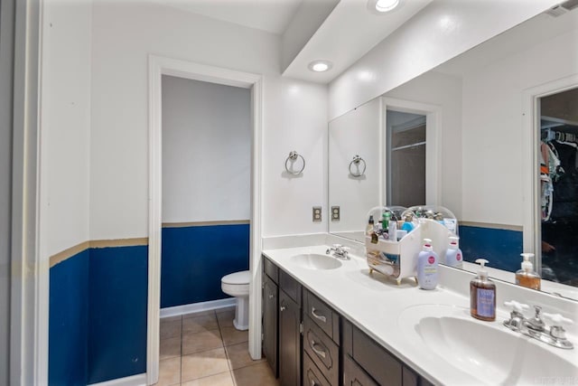 bathroom with a sink, visible vents, toilet, and tile patterned floors