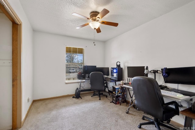 office area featuring carpet flooring, a ceiling fan, baseboards, and a textured ceiling