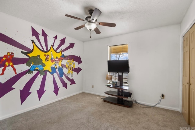 playroom featuring baseboards, carpet floors, and a textured ceiling