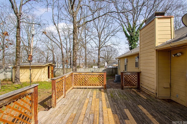 wooden terrace featuring an outdoor structure and a fenced backyard