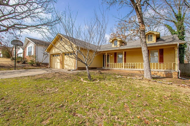 view of front of house with a front yard, covered porch, concrete driveway, and an attached garage