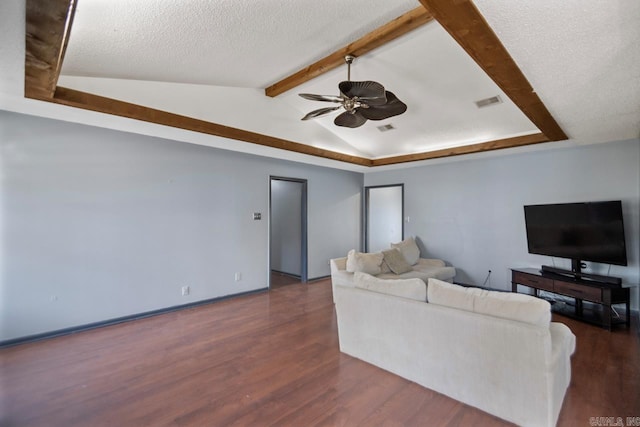 living area with a textured ceiling, lofted ceiling with beams, ceiling fan, and wood finished floors