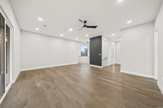 empty room featuring recessed lighting, baseboards, and wood finished floors