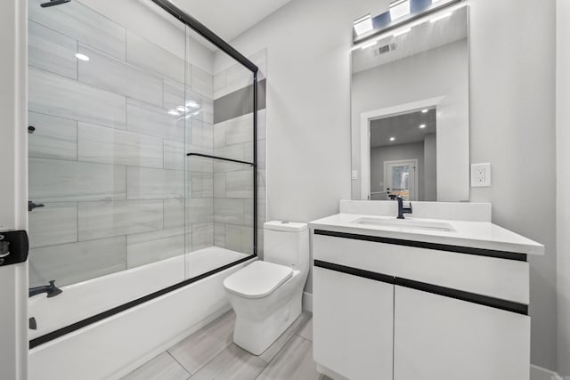 full bath with visible vents, shower / bath combination with glass door, vanity, and toilet