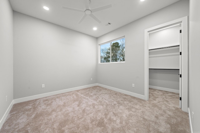 unfurnished bedroom featuring a spacious closet, visible vents, baseboards, carpet flooring, and recessed lighting