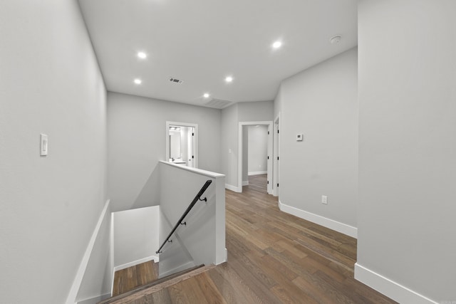 hall featuring visible vents, an upstairs landing, recessed lighting, baseboards, and dark wood-style flooring