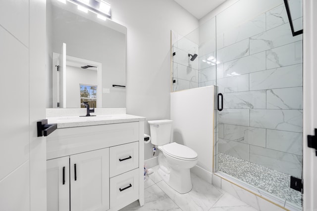 bathroom with marble finish floor, a stall shower, toilet, and vanity