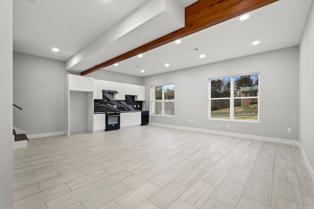 unfurnished living room with beamed ceiling, recessed lighting, and baseboards