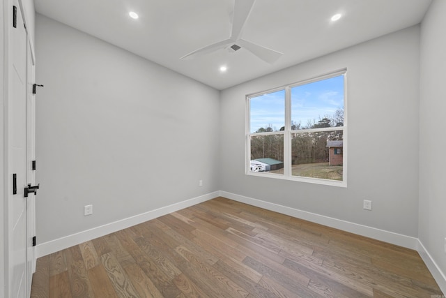 empty room featuring visible vents, wood finished floors, recessed lighting, baseboards, and ceiling fan