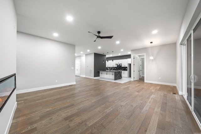 unfurnished living room with visible vents, light wood-style flooring, recessed lighting, baseboards, and ceiling fan