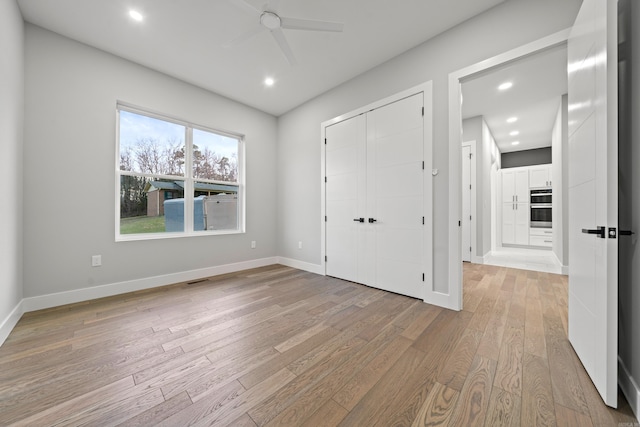 unfurnished bedroom with recessed lighting, baseboards, and light wood finished floors