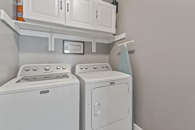 laundry room with washer and clothes dryer and cabinet space