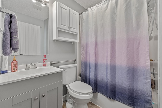 full bathroom featuring vanity, shower / tub combo, toilet, and a textured ceiling