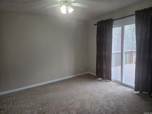 empty room with carpet flooring, ceiling fan, a textured ceiling, and baseboards