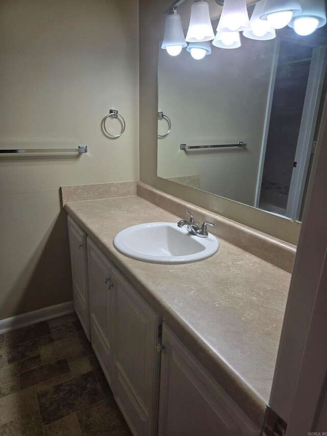 bathroom with vanity and baseboards