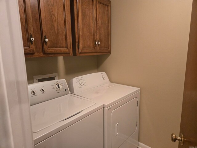 laundry room featuring cabinet space and washing machine and dryer