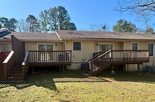 rear view of property featuring a deck, stairs, and a yard