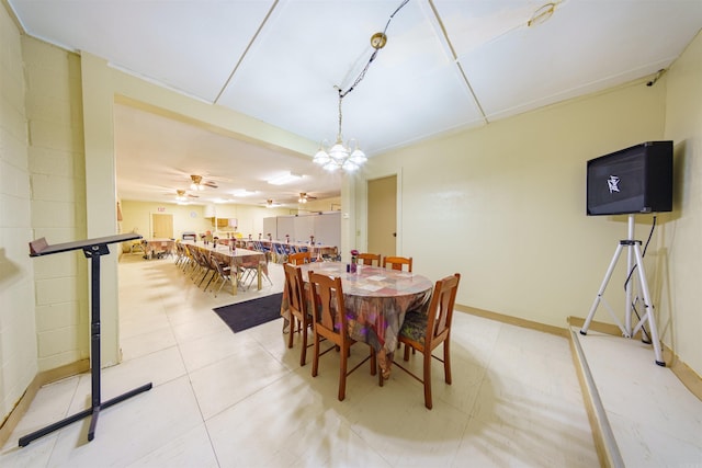 dining room with baseboards and ceiling fan with notable chandelier