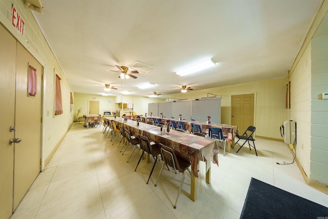 dining space with baseboards and ceiling fan