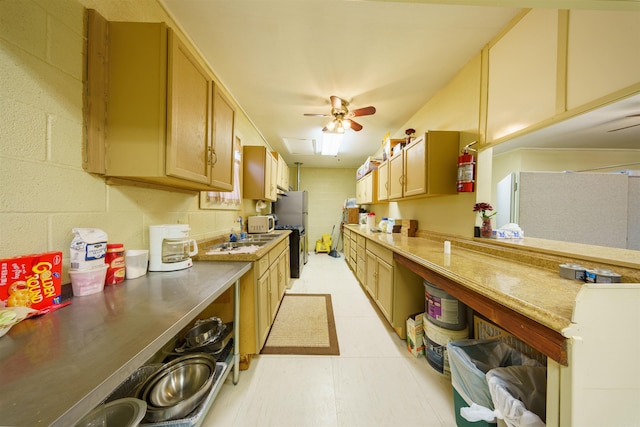 kitchen featuring freestanding refrigerator, light countertops, and a ceiling fan