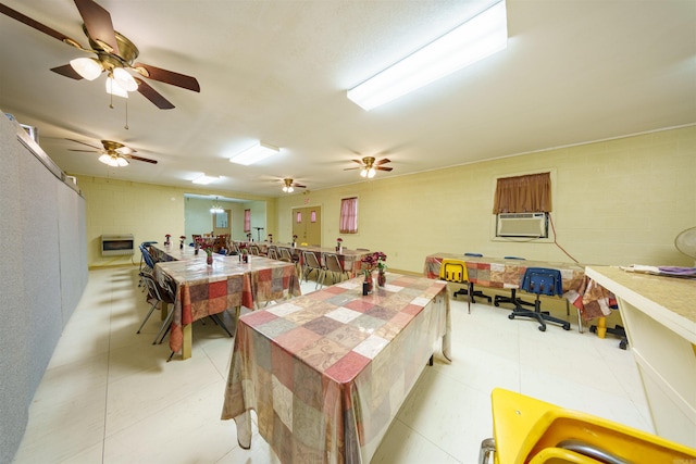 dining area featuring cooling unit and concrete block wall