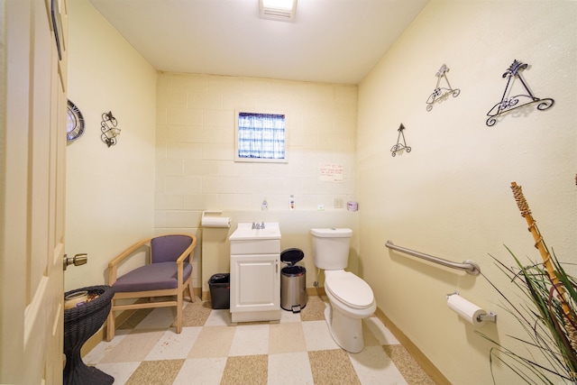 half bathroom featuring visible vents, baseboards, toilet, tile patterned floors, and a sink