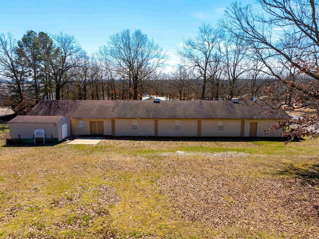 rear view of property featuring a lawn