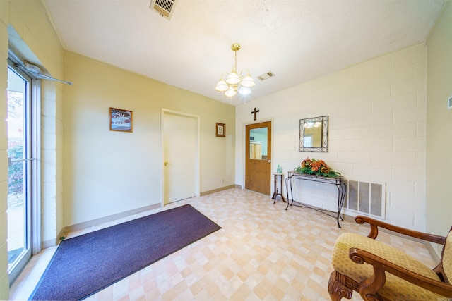 entrance foyer featuring a notable chandelier, visible vents, and light floors