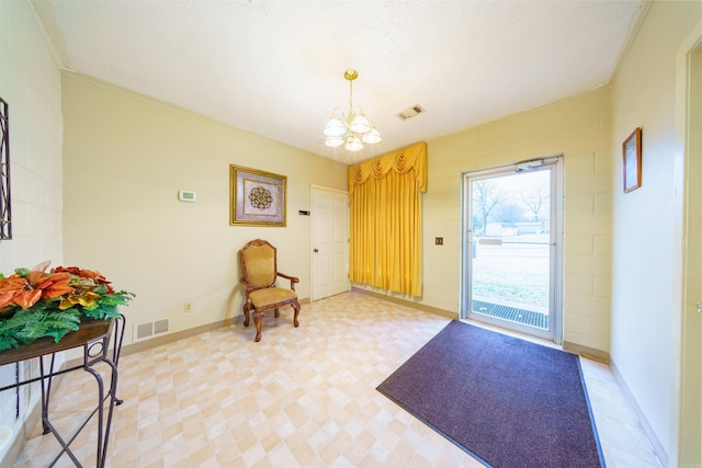 foyer featuring visible vents, baseboards, a notable chandelier, and light floors