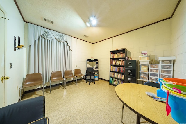 living area featuring visible vents, ornamental molding, tile patterned floors, a textured ceiling, and concrete block wall