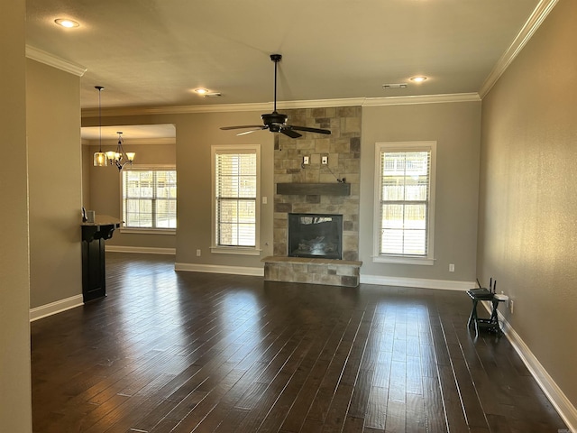 unfurnished living room featuring dark wood-style floors, a stone fireplace, crown molding, and baseboards