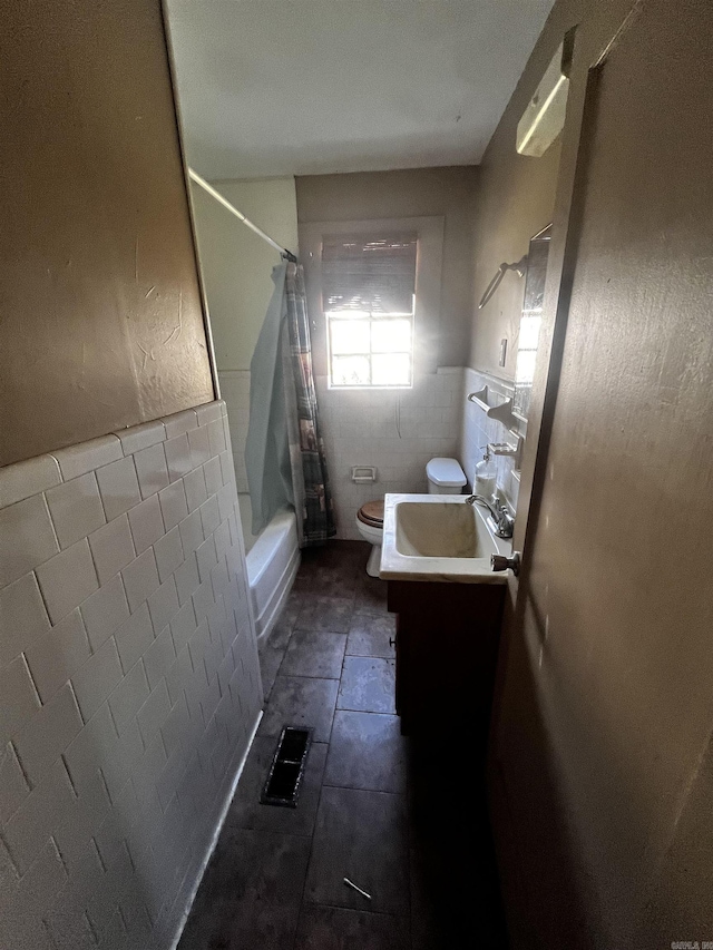 bathroom featuring tile patterned floors, visible vents, toilet, tile walls, and vanity