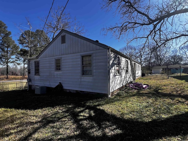 view of side of property with a yard and fence