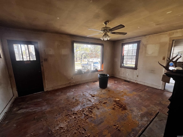 entrance foyer featuring visible vents, crown molding, and ceiling fan