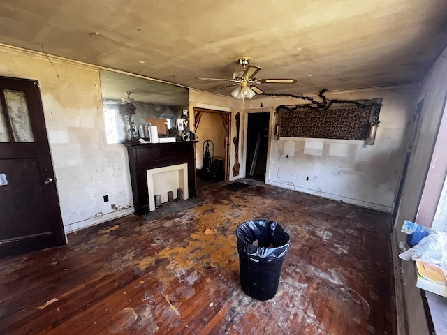 unfurnished living room featuring wood finished floors and ceiling fan