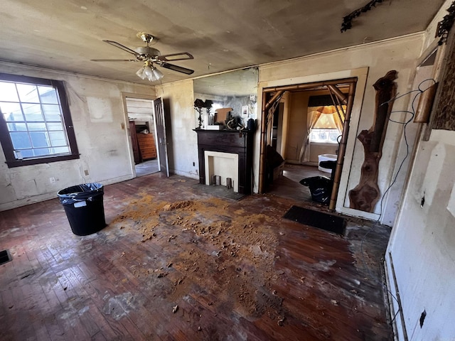 living room with a fireplace with flush hearth, a ceiling fan, and hardwood / wood-style flooring