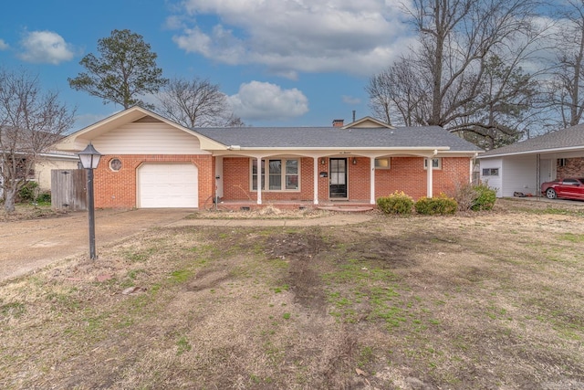 single story home with driveway, brick siding, a porch, and an attached garage