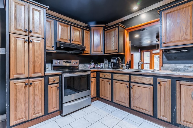 kitchen with under cabinet range hood, a sink, stainless steel electric stove, light tile patterned flooring, and light countertops