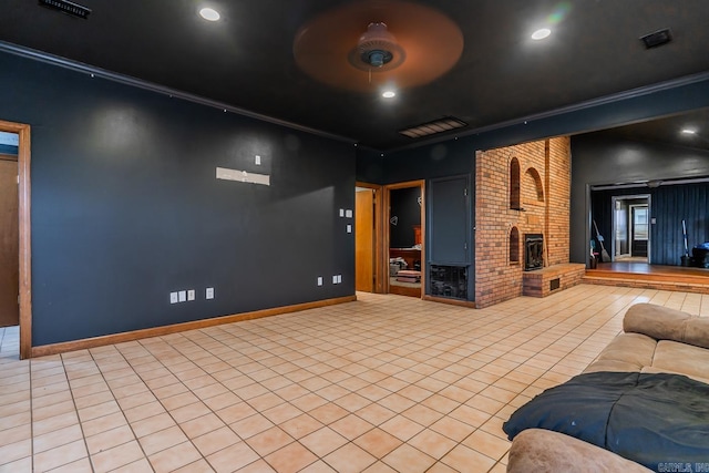 home theater room with baseboards, ornamental molding, recessed lighting, a fireplace, and tile patterned floors