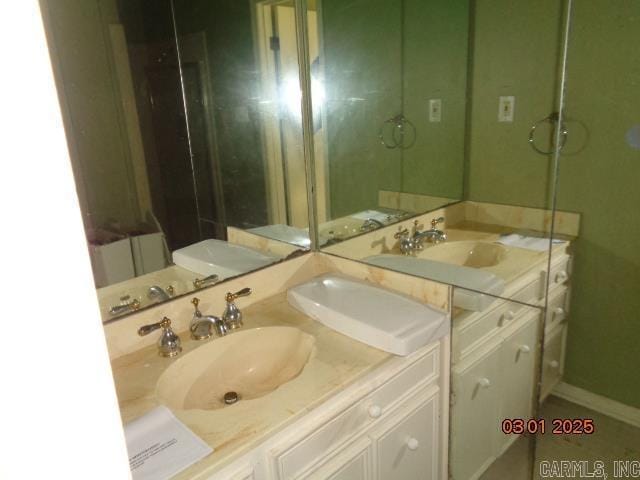 bathroom featuring baseboards and vanity