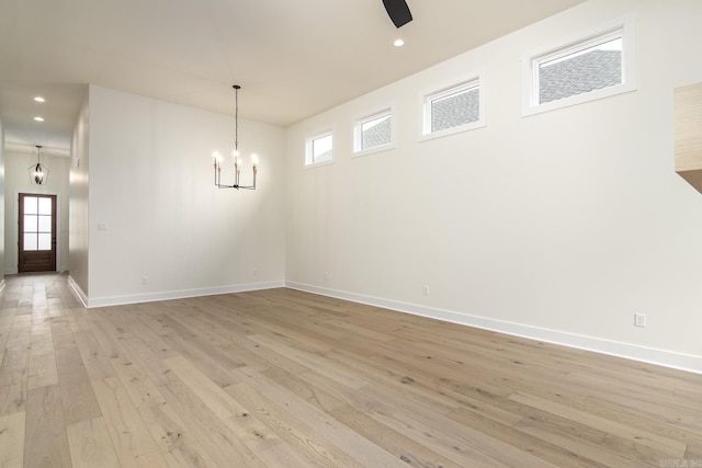 115 Fletcher Ridge Dr, Little Rock, AR 72223 - spare room featuring an inviting chandelier, recessed lighting, light wood-style floors, and baseboards
