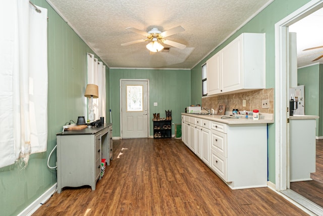 kitchen with tasteful backsplash, dark wood-type flooring, ceiling fan, freestanding refrigerator, and white cabinets