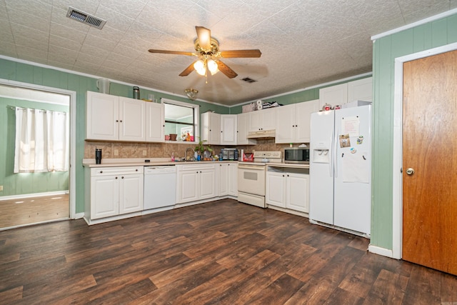 kitchen with white appliances, visible vents, dark wood-style flooring, white cabinets, and under cabinet range hood