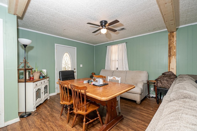 dining room with wood finished floors, baseboards, visible vents, ceiling fan, and crown molding