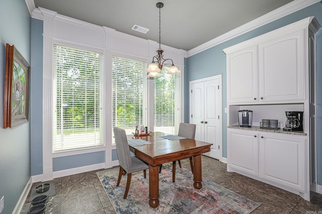 dining area with a notable chandelier, baseboards, visible vents, and ornamental molding