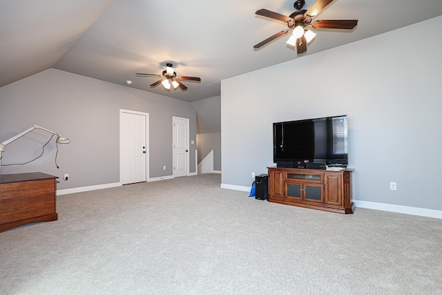 living room featuring baseboards, carpet, ceiling fan, and vaulted ceiling