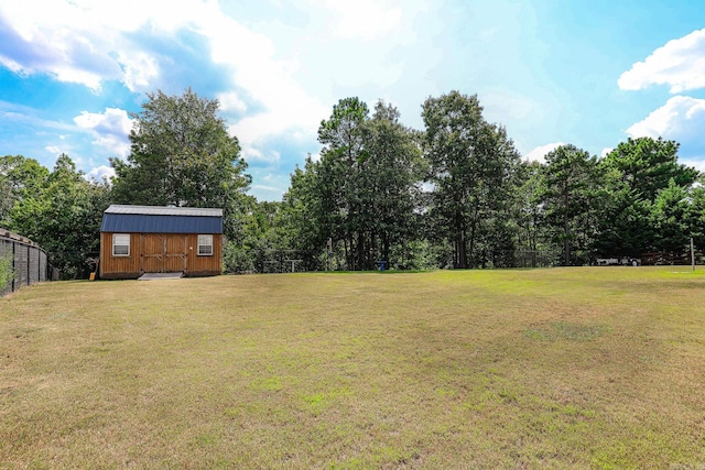 view of yard with a storage shed, an outdoor structure, and fence